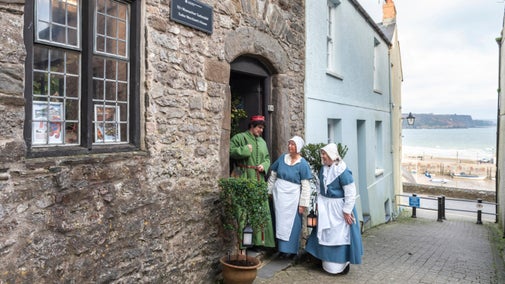 Staff dressed up outside the Tudors Tudor merchant’s House, Pembrokeshire